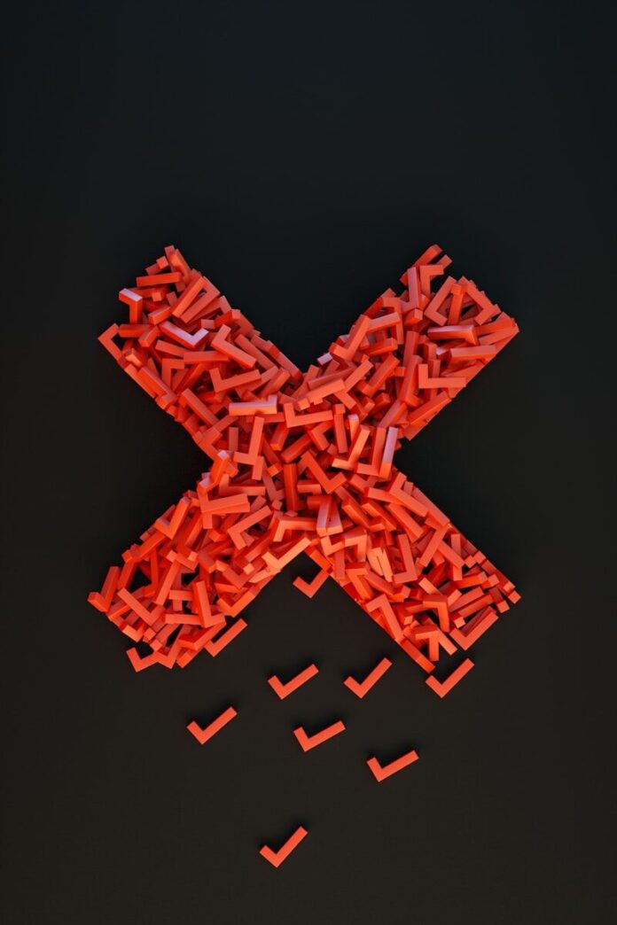 Photo by 愚木混株 Yumu a cross made out of small pieces of red plastic